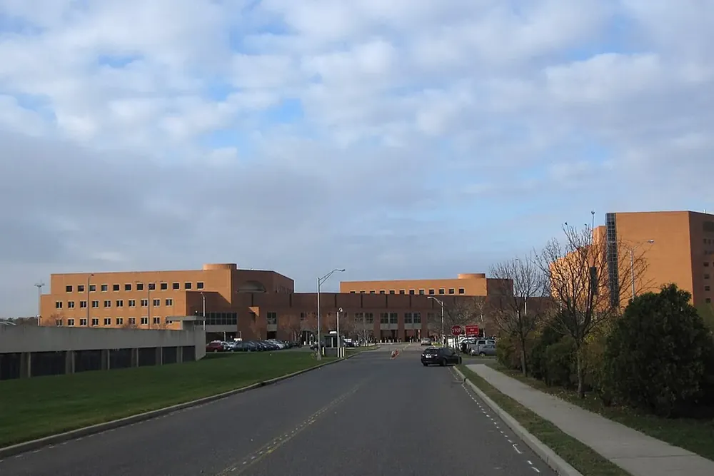 Wide road leading to a large brick government complex in Central Islip, New York