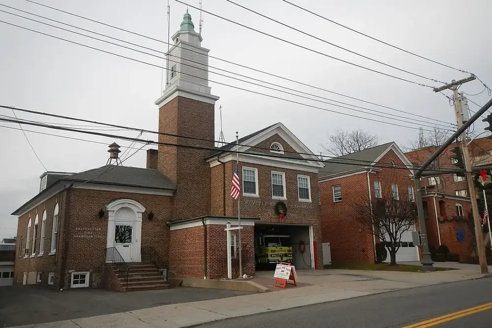 Brick firehouse with a white clock tower on Main Street in Eastchester, New York