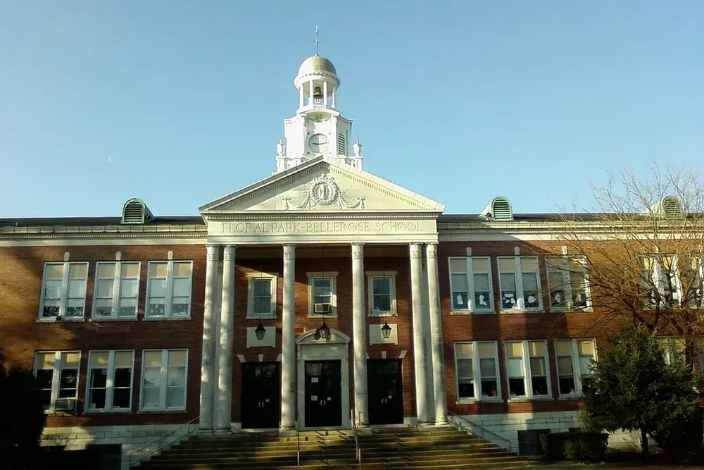 Columned brick school building with a white cupola in Floral Park, New York