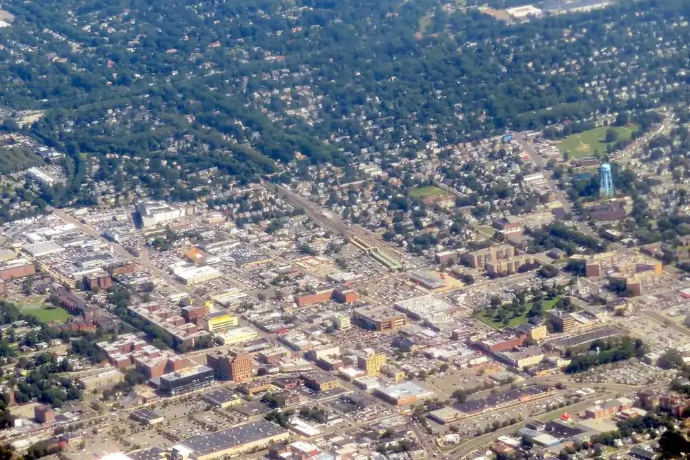 Aerial view of the village of Hempstead with dense streets, buildings and trees, New York