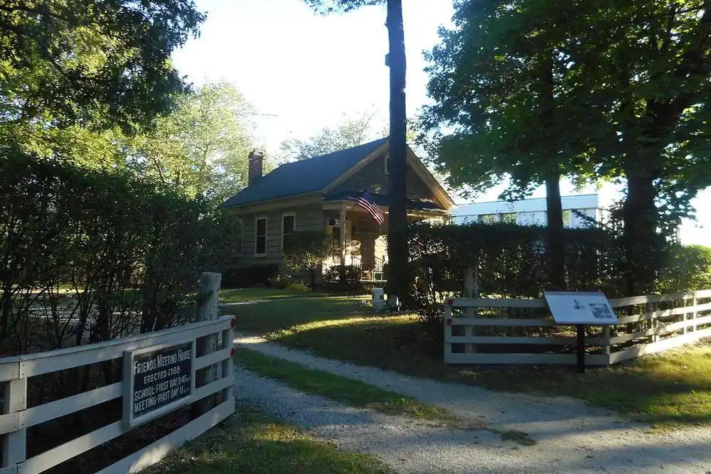 Garden path leading to the historic Friends Meetinghouse among tall trees in Jericho, New York