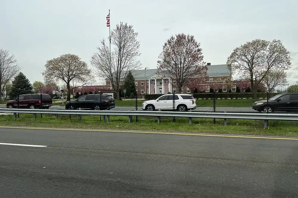 Brick Town of Babylon Town Hall behind lawns and flowering trees in North Lindenhurst, New York