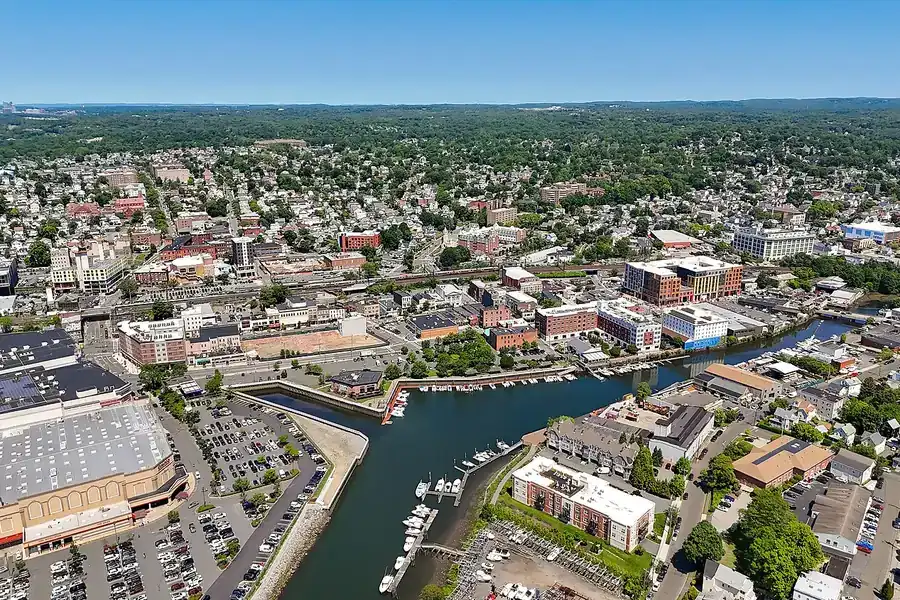Aerial view of Port Chester with the Byram River harbor and village streets, New York