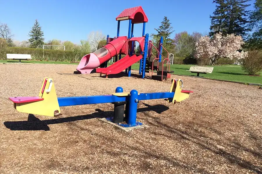 Colorful playground with a slide and seesaw in a park in Rye, New York