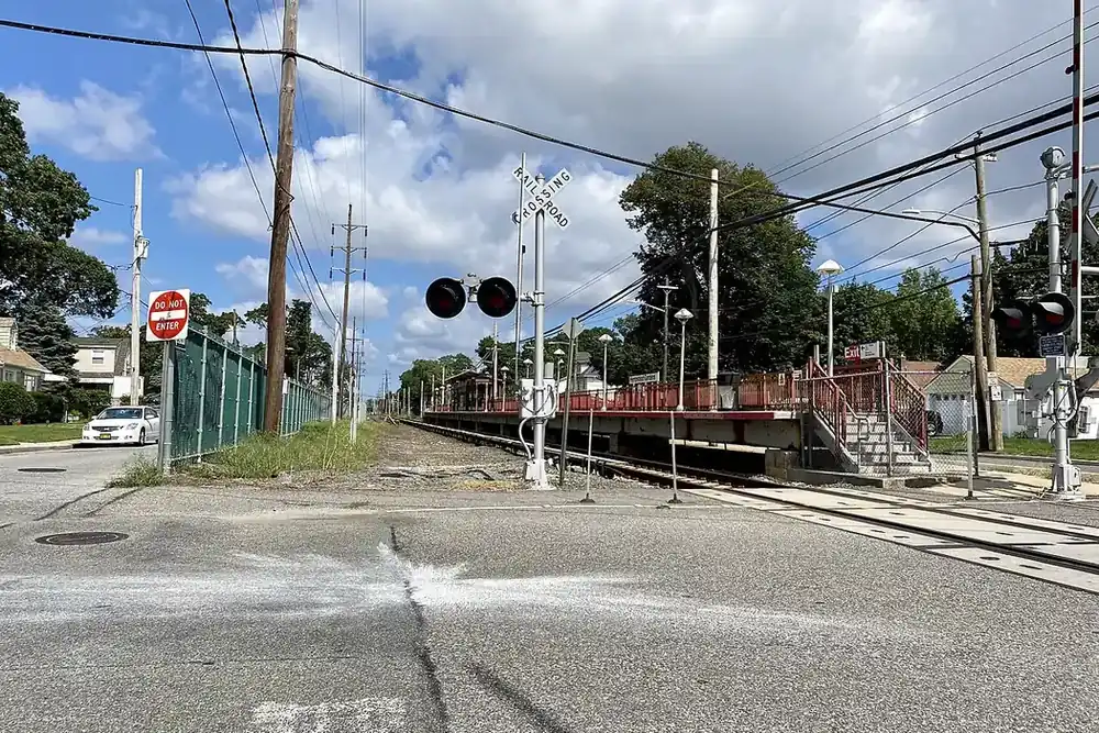 Railroad crossing and small station beside a residential street in West Hempstead, New York